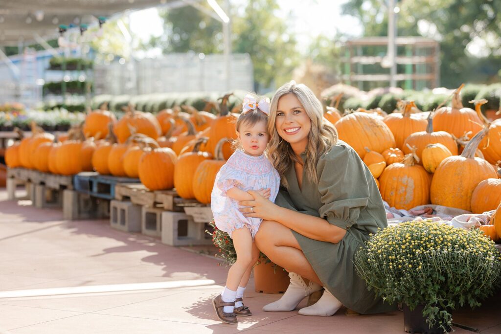 Mother and daughter hugging in pumpkin patch during Shreveport family photography.