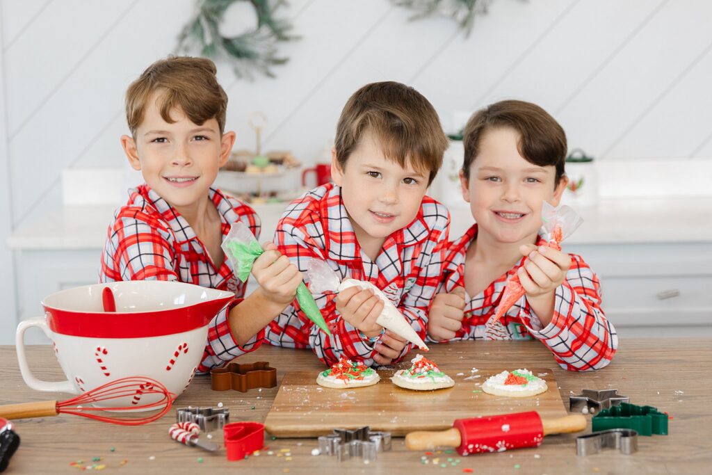 3 brothers decorating Christmas cookies
