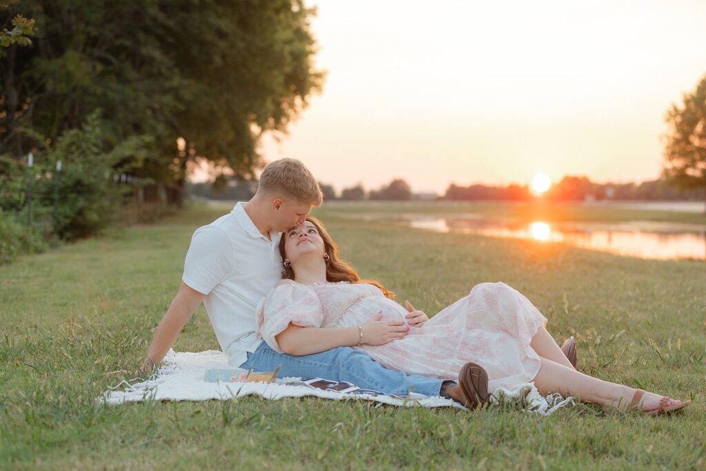 Couple laying in field looking at each other