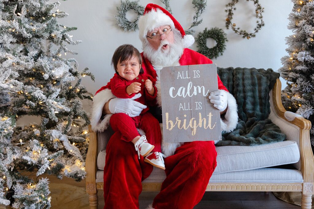 Boy crying on Santa's lap