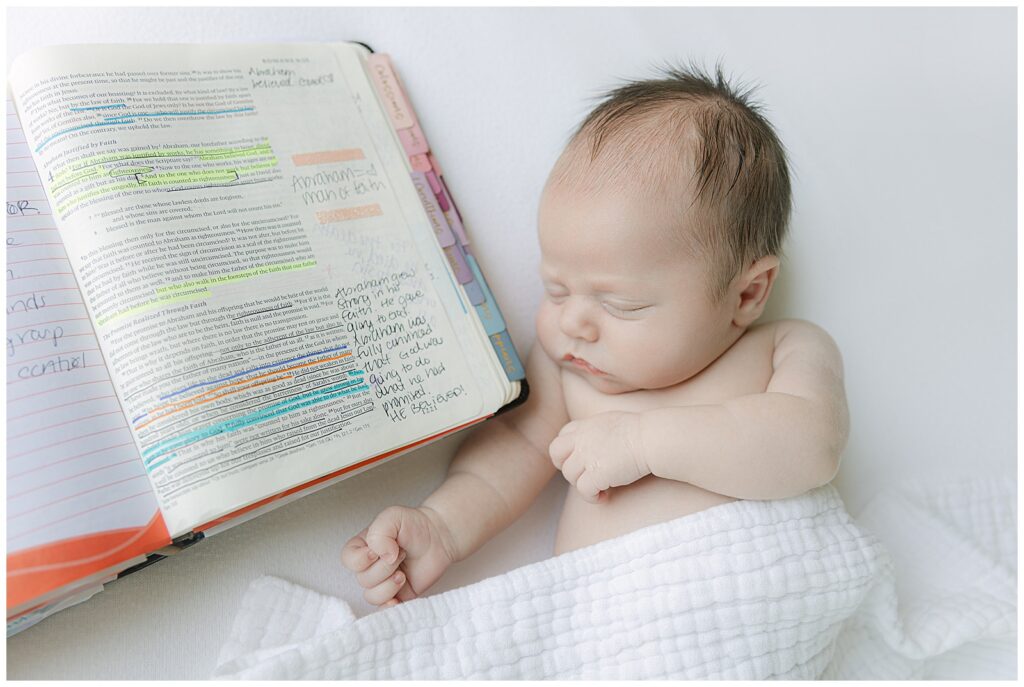 Newborn baby photography Benton LA featuring meaningful family heirloom Bible